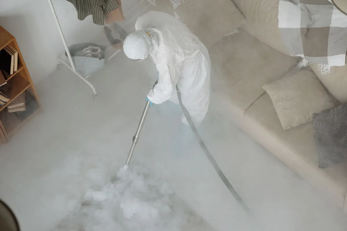 Biohazard cleanup technician in protective equipment, Seymour, WI